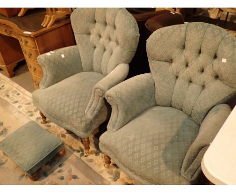 Pair of antique style upholstered button back armchairs with brass castors and foot rest