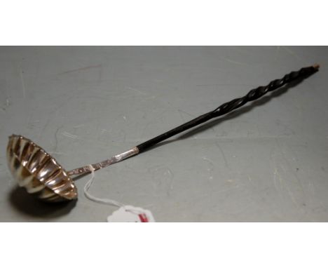A  George III white metal  toddy ladle on turned whale bone handle