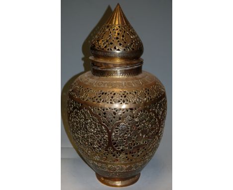 A Middle Eastern brass lantern and cover of pierced baluster form 