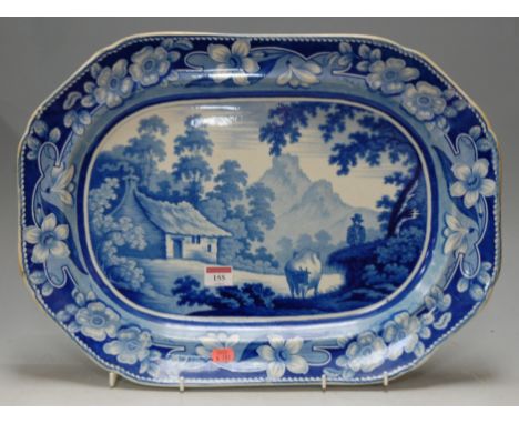 A 19th century Staffordshire blue and white printed meat plate, printed with a landscape with figure and cattle within a flor