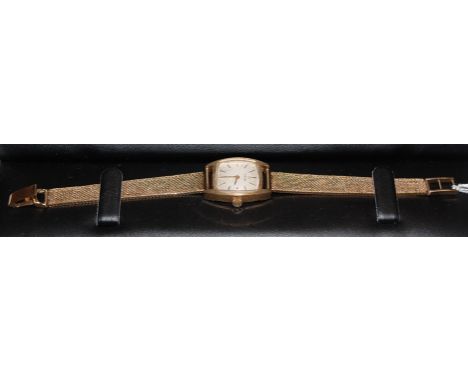 A ladies Omega 9ct gold bracelet watch having signed silvered dial with baton markers and manual wind movement, gross weight 