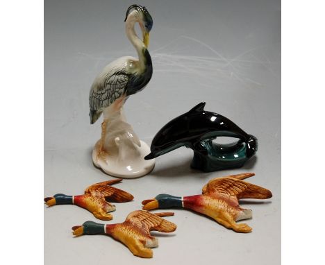 A Karl Ens ceramic heron; a Poole Pottery dolphin; and a set of three Beswick style flying ducks (3)