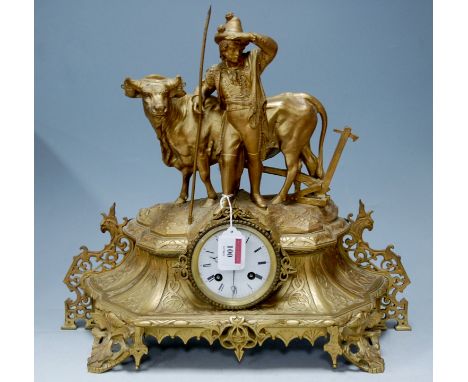 A 19th century French gilt metal mantel clock, the case signed Trouillard and surmounted with a gentleman farmer with his ox 