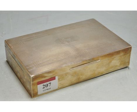 An engine turned silver table cigarette box with engraved presentation inscription