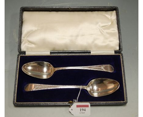 A pair of mid-18th century silver tablespoons in the Old English pattern, each with bright cut engraved decoration and housed