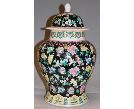 A Chinese enamel decorated stoneware baluster form vase and cover