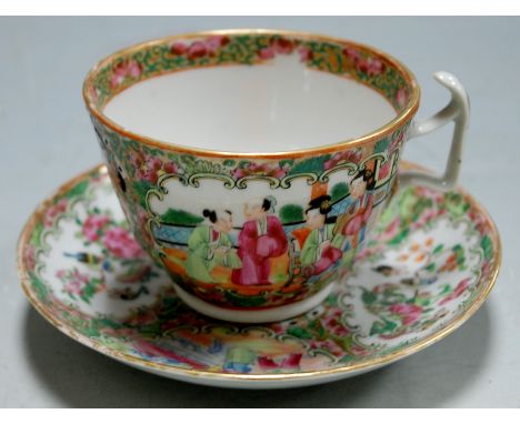A Chinese Canton teacup and saucer, each enamel decorated and heightened in gilt 