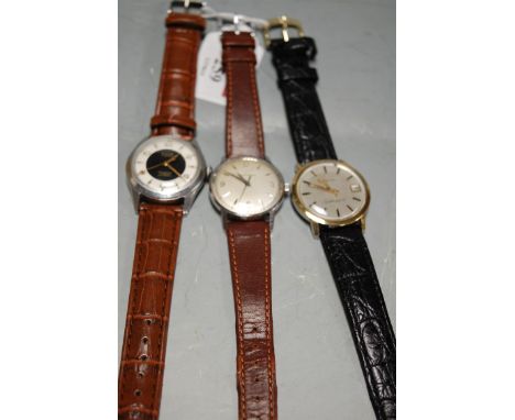 A gents Eterna Matic wristwatch, having silvered dial with baton markers, on leather strap; together with two other gents wri