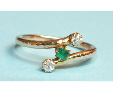 An emerald and diamond cross-over ring, claw-set a square-cut emerald between two old-cut diamonds, in unmarked rose gold mou