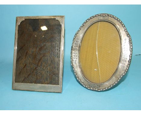 A rectangular engine-turned photograph frame, 17 x 11.5cm, Birmingham 1926 and an engraved oval photograph frame, 17 x 13.5cm