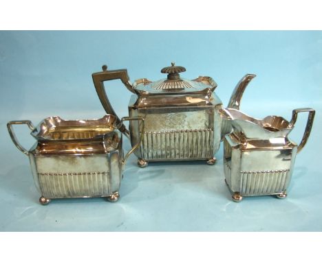 A late-Victorian half-reeded three-piece tea service of oblong shape, on ball feet, Sheffield 1891, maker HS, bases engraved 