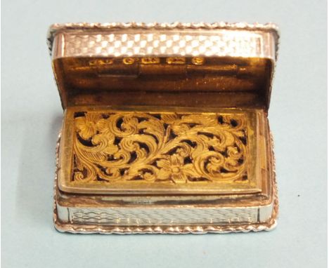 A Victorian silver rectangular vinaigrette by George Unite, the scroll-moulded rim around an engine-turned body, enclosing a 