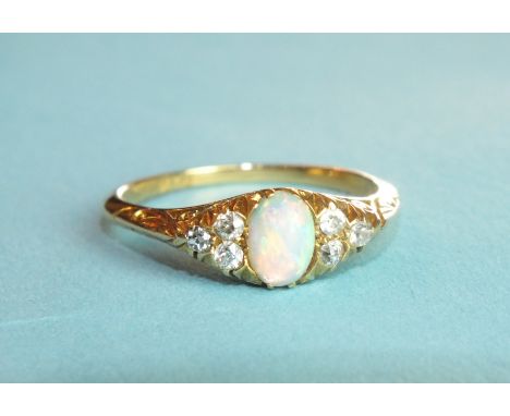 An opal and diamond ring set an opal between triplets of diamond points, in 18ct gold mount, size P, 3g.