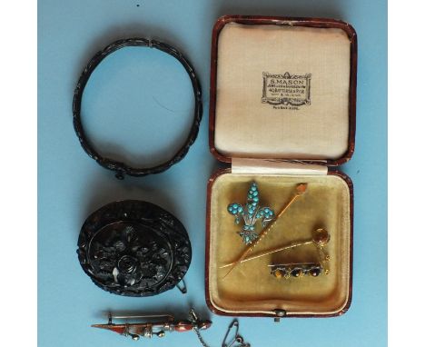 A large Victorian jet brooch of floral design, (damage to edge), a jet and metal hinged bangle, a Scottish hardstone dirk bro