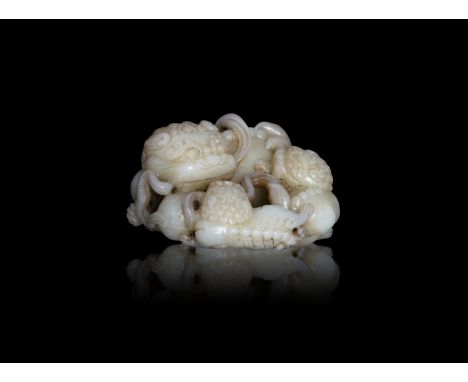 A CARVED CELADON 'BUDDHIST LION' JADE GROUP  20世紀初 青玉太獅少獅擺件  the recumbent lion is carved looking over its back, the tail fli