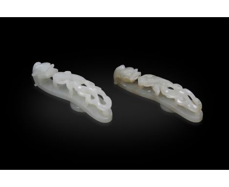 TWO PALE CELADON JADE BELT HOOKS  清代 青白玉龍鉤兩件  China, 19th century.  Both carved with a sinuous two chilong dragons, one formi