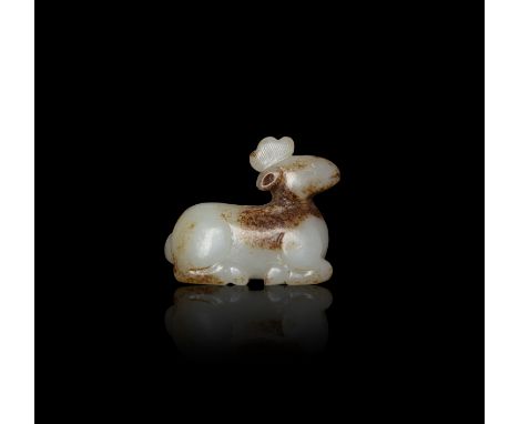 A WHITE AND RUSSET JADE RECUMBENT DEER  清仿宋 白玉帶沁色臥鹿  China, Qing dynasty.  L: 4cm