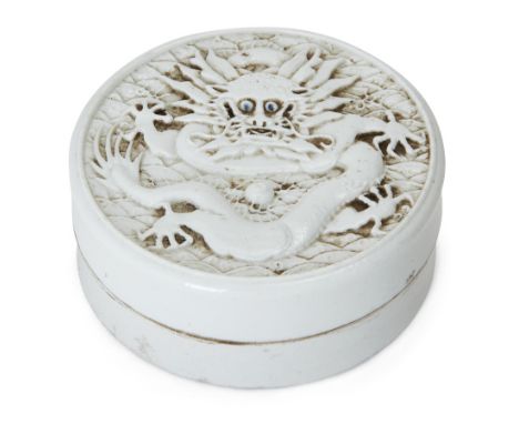 A Chinese white-glazed biscuit porcelain circular inkstone and cover, Republic period, moulded to the cover with a confrontin