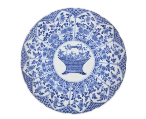 A Chinese porcelain blue and white 'basket of flowers' dish, 20th century, painted to the centre with a circular panel enclos