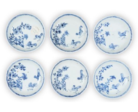 A set of six Chinese blue and white 'cockerel' saucers, 18th century, each similarly painted to the interior with cockerels b