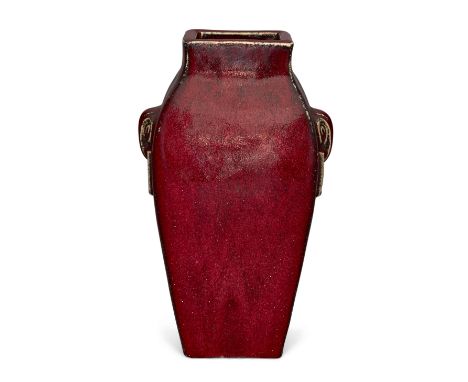 A Chinese archaistic monochrome copper red vase, late Qing dynasty, of rectangular form moulded with stylised elephant mask r