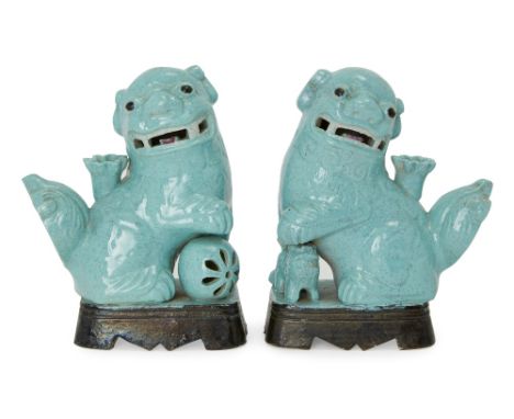 A pair of Chinese robin's egg-glazed Buddhist lion joss-stick holders, first half of 20th century, 14cm high (2).二十世紀前半葉 爐鈞釉佛