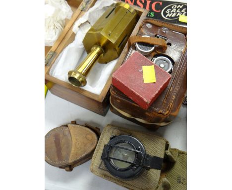 A boxed brass compass together with two leather cased military campuses, vintage camera etc