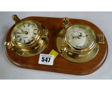 A modern wall mounted barometer / clock set