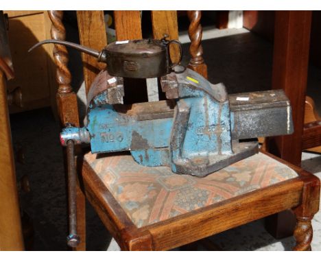 A vintage bench vice together with a vintage Browns Iron Mongers of Cardiff oil can