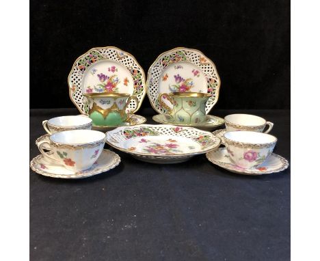 Two Meissen Porcelain tea cups and saucers, one of lotus flower pattern, of green ground with scattered floral sprays to each