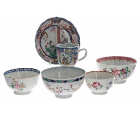 Chinese famille rose porcelain teacup and saucer,&nbsp;depicting figures at a table within an underglaze blue border with car