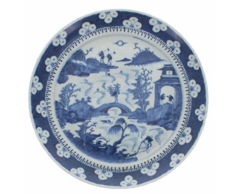 Chinese blue and white porcelain circular plate, depicting figures working in landscapes within a prunus border, bearing Kang