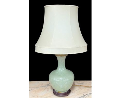 Chinese celadon glaze bottle vase converted to a table lamp, with incised decoration, upon a later stand with shade, the vase