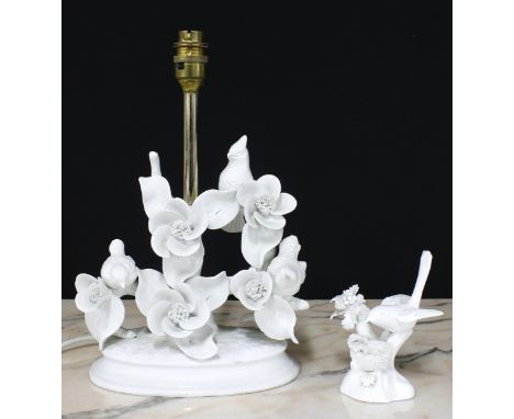 Blanc de Chine porcelain table lamp modelled with birds on branches, with shade; together with a small porcelain bird figure 