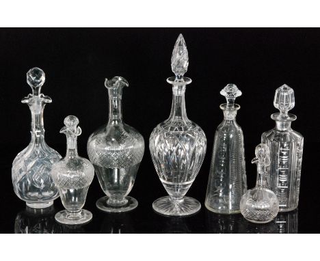 A group of John Walsh Walsh decanters comprising globe and shaft and sleeve form examples, each with varying cut decoration, 