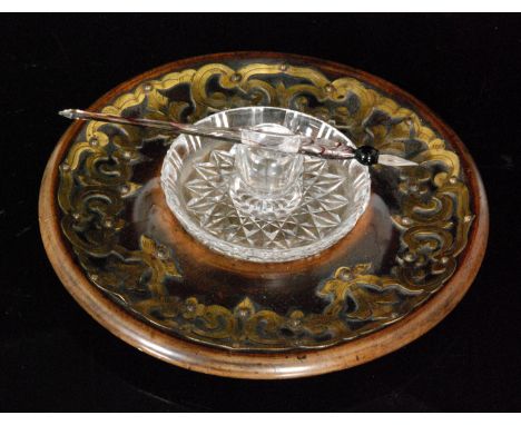 A John Walsh Walsh glass inkwell and quill, raised on a turned stained beech stand with foliate brass detailing, diameter 22c