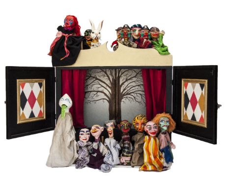 A PUPPET THEATRE,late 20th century, an unusual puppet theatre with fifteen wooden headed puppets, 100cm wide, 21cm deep, 95cm