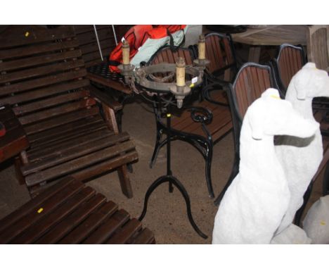 A metal plant stand and a three branch light fitting