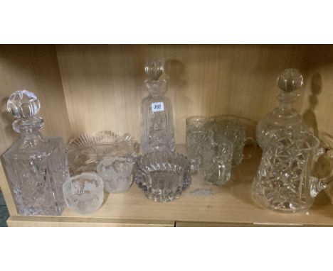 SHELF OF CUT GLASSWARE INCL; 3 DECANTERS, WATER JUG, BOWLS ETC