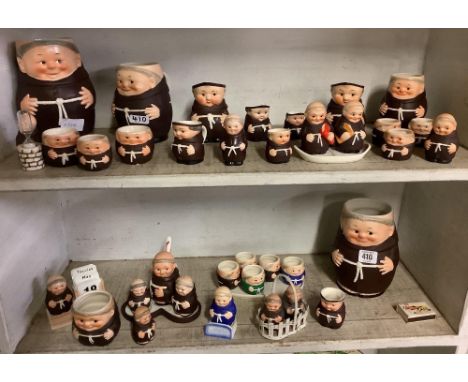 2 SHELVES OF GOEBEL MONKS WITH MUGS, CRUET SETS, EGG CUPS ETC