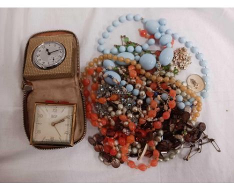 A TIN WITH NECKLACES, ALARM CLOCK ETC
