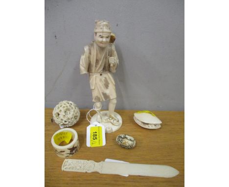 Early 20th century ivory to include a Chinese puzzle ball, a netsuke canton shell, a Japanese figure, a letter knife, a napki