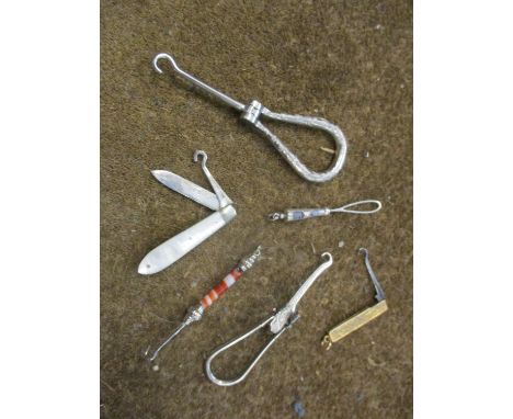A small lot comprising a silver and mother of pearl fruit knife, a silver and agate button hook, other silver and white metal