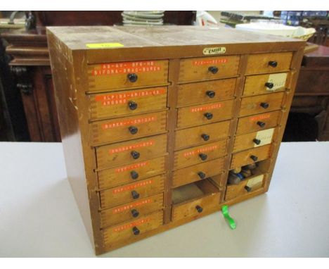 An early 20th century collectors cabinet by 'Emir' with twenty three drawers filled with watch components and tools to includ