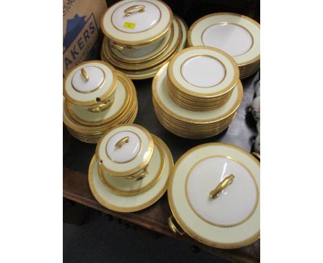 A Royal Worcester Coronet bone china part dinner service having a wide cream coloured banding with gilt coloured rim and gilt