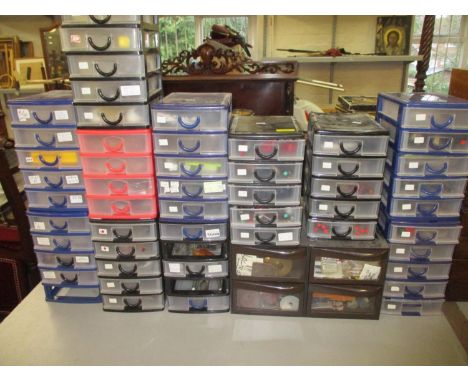 A collection of watch and clock makers tools in twelve plastic table top chests, to include screwdrivers, cravers, batteries 