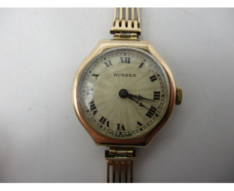 An early 20th century Burnex 9ct gold ladies manual wind wristwatch on a 15ct gold bracelet. The dial having Roman numerals a