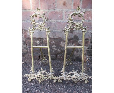 A pair of mid to late 20th century ornate brass table top picture easel display stands together with an Oriental needlepoint 