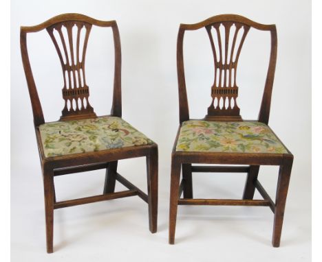 A set of five George III country Hepplewhite oak dining chairs, with pierced splats and drop in tapestry seats on tapered leg
