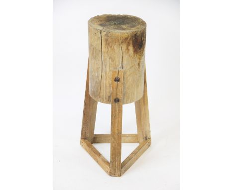 A late 19th / early 20th century heavy pine butchers block, probably French the cylindrical block on an out-swept tripod base